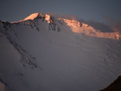 09C The first rays of sunrise burn the Lenin Peak summit ridge orange from Ak-Sai Travel Lenin Peak Base Camp 3600m
